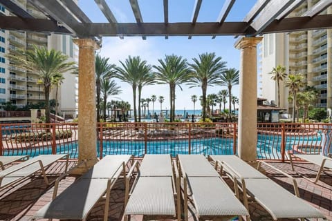 Property building, Patio, Day, Natural landscape, View (from property/room), Pool view, Sea view, Swimming pool, sunbed