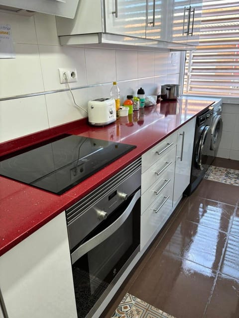 Kitchen or kitchenette, microwave, stove, toaster, washing machine