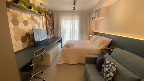 Bed, TV and multimedia, Living room, Seating area, Bedroom