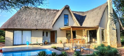 Property building, Patio, Pool view, Swimming pool, sunbed