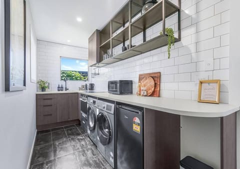 Kitchen or kitchenette, dishwasher, oven, stove, toaster, washing machine, dryer