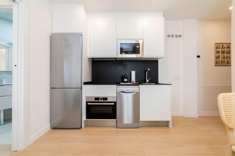 Kitchen or kitchenette, dishwasher, microwave, oven, stove