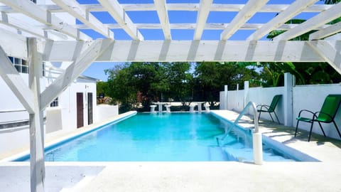 Property building, Patio, Day, Natural landscape, Seating area, Pool view, Swimming pool, sunbed