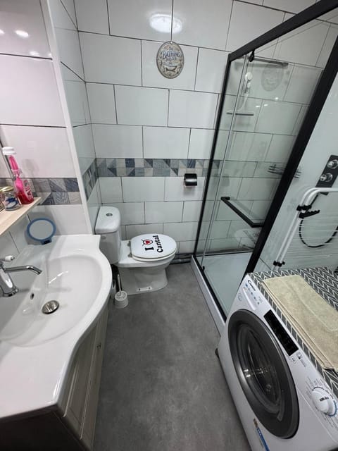 Shower, Toilet, Bathroom, towels, washing machine, dryer