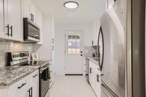 Kitchen or kitchenette, dishwasher, microwave, oven, stove