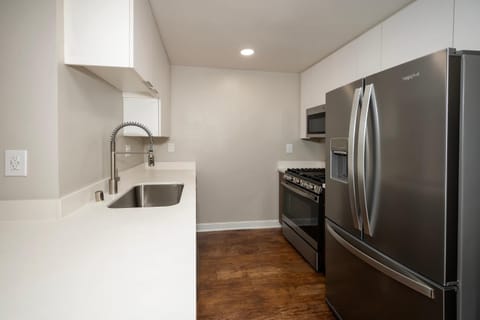 Kitchen or kitchenette, dishwasher, oven, stove