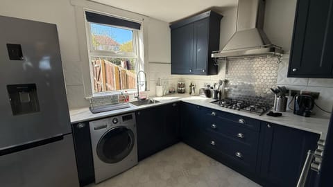 Kitchen or kitchenette, microwave, oven, stove, toaster, washing machine