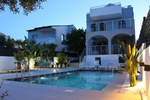 Property building, Patio, Pool view, Swimming pool, sunbed