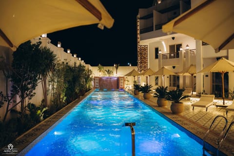 Property building, Night, Natural landscape, Pool view, Swimming pool, sunbed