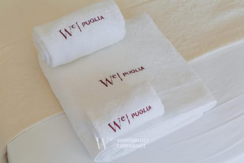 Bed, Photo of the whole room, Bedroom, Text overlay, towels