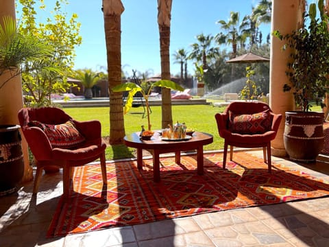 Property building, Patio, Spring, Day, Garden, Living room, Seating area, Garden view, Pool view, Swimming pool