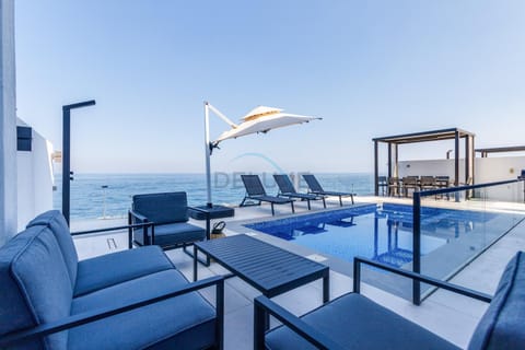 View (from property/room), Seating area, Pool view, Sea view, Swimming pool
