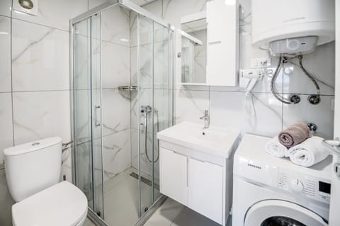 Shower, Toilet, Bathroom, towels, washing machine, dryer