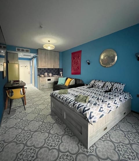 Bed, Photo of the whole room, Seating area, Dining area, Bedroom, furniture, microwave, stove, kitchen, air conditioner