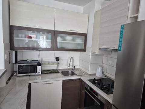 Kitchen or kitchenette, dishwasher, microwave, oven, stove
