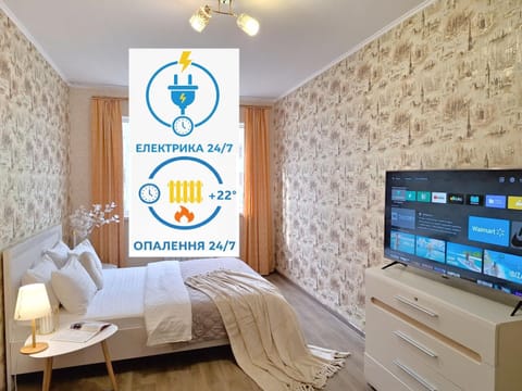 Bed, Property logo or sign, TV and multimedia, Photo of the whole room, Logo/Certificate/Sign, Bedroom, Text overlay, Certificate/Award
