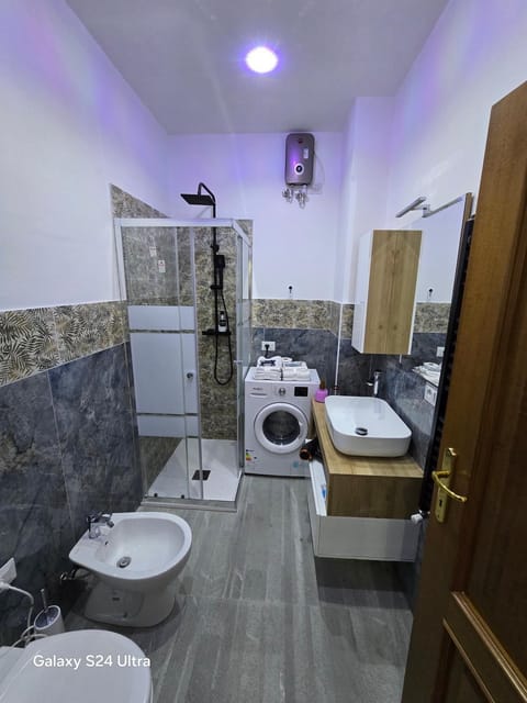 Shower, Toilet, Bathroom, bidet, towels, washing machine, dryer