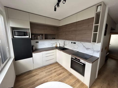 Kitchen or kitchenette, dishwasher, microwave, oven, stove