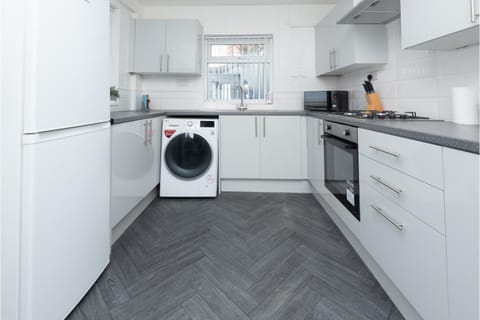 Kitchen or kitchenette, microwave, oven, stove, washing machine