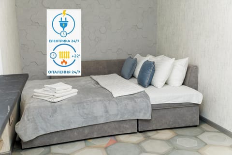 Bed, Property logo or sign, Photo of the whole room, Logo/Certificate/Sign, Bedroom, Text overlay, Certificate/Award, towels