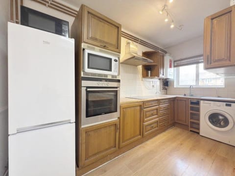 Kitchen or kitchenette, oven, stove, washing machine