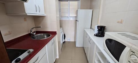Kitchen or kitchenette, washing machine