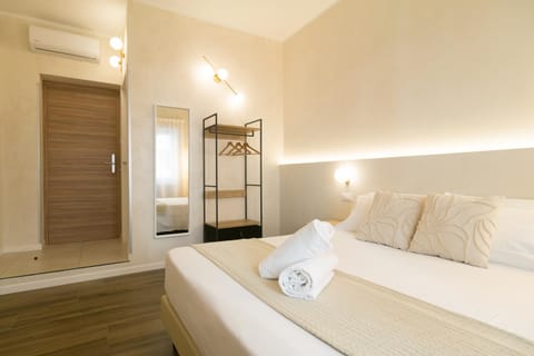 Bed, Decorative detail, Bedroom, hair dryier, towels, wardrobe, air conditioner
