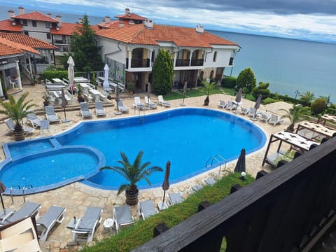 Property building, Patio, Natural landscape, Pool view, Sea view, Swimming pool, sunbed