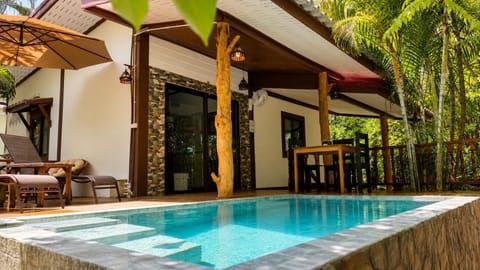 Property building, Patio, Pool view, Swimming pool, sunbed