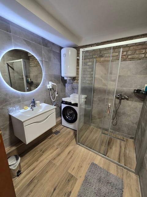 Shower, Toilet, Bathroom, hair dryier, towels, washing machine