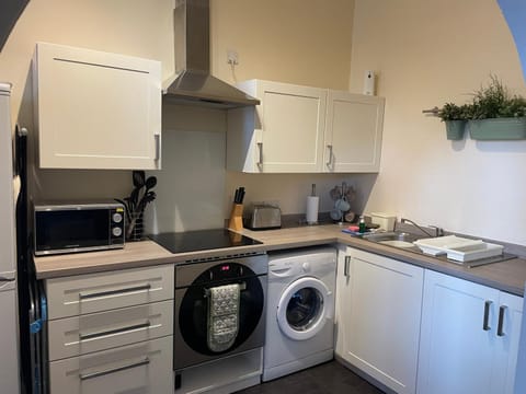 Kitchen or kitchenette, stove, toaster, washing machine