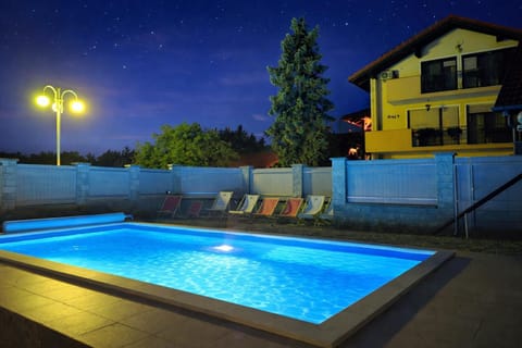 Property building, Patio, Night, Natural landscape, Pool view, Swimming pool, sunbed
