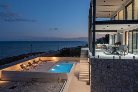Property building, Patio, Night, View (from property/room), Balcony/Terrace, Pool view, Sea view, Swimming pool, sunbed