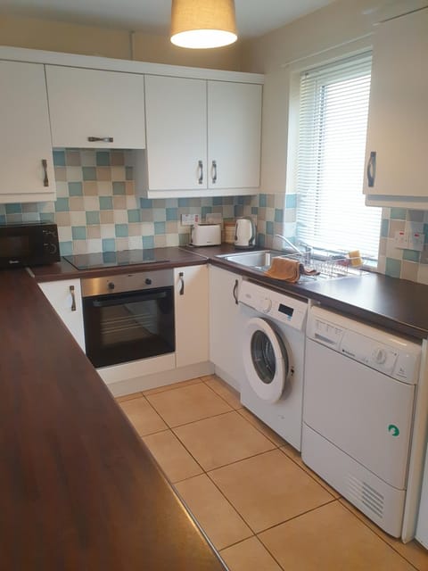 Kitchen or kitchenette, oven, stove, washing machine, dryer
