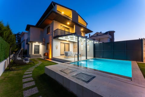 Property building, Patio, Night, Pool view, Swimming pool, sunbed