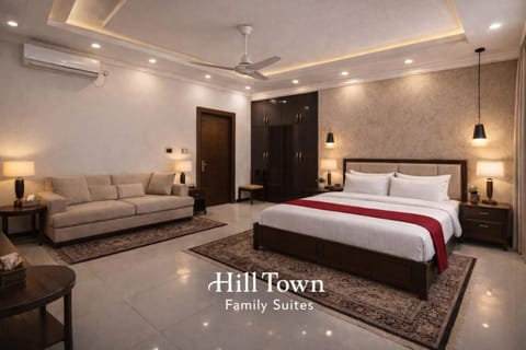 Bed, Property logo or sign, Living room, Photo of the whole room, Seating area, Logo/Certificate/Sign, Bedroom, Text overlay, Certificate/Award, towels, air conditioner