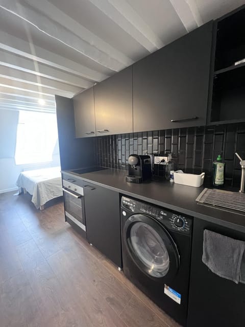 Kitchen or kitchenette, stove, washing machine, dryer