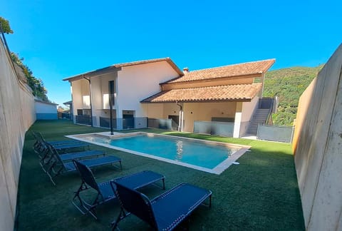 Property building, Patio, Pool view, Swimming pool, sunbed