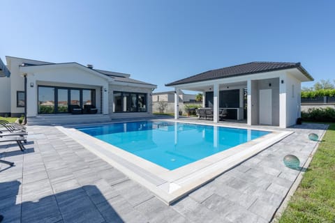 Property building, Patio, Pool view, Swimming pool, sunbed