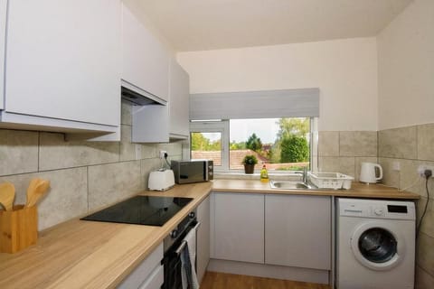 Kitchen or kitchenette, stove, toaster, washing machine