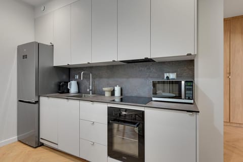 Kitchen or kitchenette, microwave, oven, stove