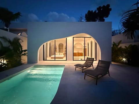 Property building, Patio, Night, Natural landscape, Living room, Seating area, Pool view, Swimming pool, sunbed