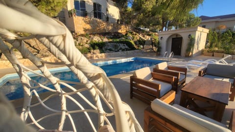 Property building, Patio, Day, Natural landscape, Living room, Seating area, Pool view, Swimming pool, sunbed