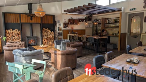Communal lounge/ TV room, Game Room, Lounge or bar, Decorative detail, Area and facilities, Drinks, Alcoholic drinks, group of guests, Family, fireplace, minibar