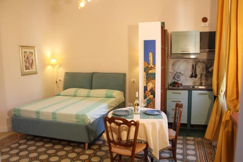 Bed, Kitchen or kitchenette, Seating area