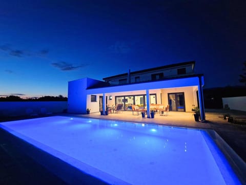 Property building, Patio, Night, Natural landscape, Pool view, Swimming pool, sunbed
