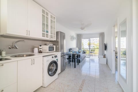 Kitchen or kitchenette, furniture, microwave, stove, toaster, washing machine