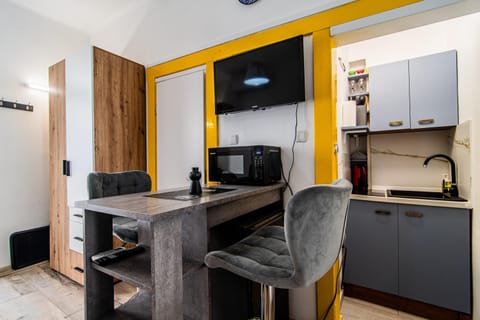 TV and multimedia, Kitchen or kitchenette, Decorative detail, Dining area, microwave, wardrobe