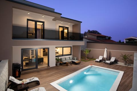 Property building, Patio, Night, Natural landscape, View (from property/room), Balcony/Terrace, Seating area, Pool view, Swimming pool, sunbed