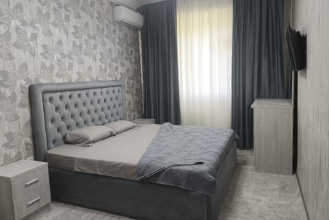 Bed, TV and multimedia, flat iron, hair dryier, towels, wardrobe, dryer, air conditioner